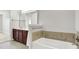 Bathroom with vanity, mirror, lighting, and a soaking tub at 127 Coatsville Dr, Westfield, IN 46074