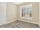 Serene bedroom with neutral carpet, walls and a window with classic shutters, inviting relaxation at 127 Coatsville Dr, Westfield, IN 46074