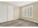 Cozy bedroom with neutral walls, plush carpet, and a window with plantation shutters at 127 Coatsville Dr, Westfield, IN 46074