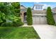 Charming home featuring a stone facade, manicured lawn, and mature trees enhancing curb appeal at 127 Coatsville Dr, Westfield, IN 46074