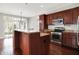Spacious kitchen featuring dark wood cabinets, stainless steel appliances, and an island at 127 Coatsville Dr, Westfield, IN 46074