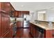Modern kitchen featuring stainless steel appliances, dark cabinets, and granite countertops at 127 Coatsville Dr, Westfield, IN 46074