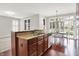 Open kitchen area with dark wood cabinets, an island with seating, and hardwood floors at 127 Coatsville Dr, Westfield, IN 46074