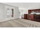 Bright living room with neutral carpet, flowing into kitchen with dark cabinetry and eat-in breakfast bar at 127 Coatsville Dr, Westfield, IN 46074