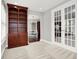 Bonus room with large bookshelf, neutral carpet, and open archway at 127 Coatsville Dr, Westfield, IN 46074