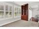 Bonus room with large bookshelf, neutral carpet, and windows with shutters at 127 Coatsville Dr, Westfield, IN 46074