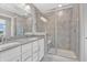 Modern bathroom featuring dual sinks, a walk-in shower with glass door and tile surround at 14226 Frostburg Dr, Carmel, IN 46033