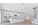 Modern kitchen with stainless steel appliances, white cabinets and a center island at 14226 Frostburg Dr, Carmel, IN 46033