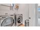 Bright laundry room with a front load washer and dryer and ample storage at 14226 Frostburg Dr, Carmel, IN 46033