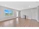 Bright living area with wood floors, featuring a large window, and open doorway for easy access to the outdoors at 14226 Frostburg Dr, Carmel, IN 46033