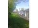 Large backyard with green grass, a firepit, a grill on the porch, and a sturdy fence at 1433 Charles St, Indianapolis, IN 46225