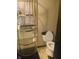 This bathroom features a toilet and a gold colored shelving unit with various household products displayed at 1433 Charles St, Indianapolis, IN 46225