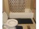 This bathroom features a toilet, a bathtub, and a shower curtain with geometric patterns at 1433 Charles St, Indianapolis, IN 46225