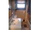 Bathroom with vanity, toilet, window, and shower/tub combo at 1433 Charles St, Indianapolis, IN 46225
