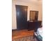 Bedroom featuring a dresser with a large mirror, wooden floors, and a bed at 1433 Charles St, Indianapolis, IN 46225