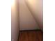 View of a closet with wood floors, light tan walls, and piping at 1433 Charles St, Indianapolis, IN 46225