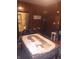 Dining area featuring wood-paneled walls, a table covered with papers, and a doorway leading to another room at 1433 Charles St, Indianapolis, IN 46225