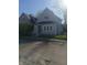 Street view of a two-story home featuring siding, a well-maintained lawn, and a secure chain-link fence at 1433 Charles St, Indianapolis, IN 46225
