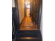Hallway featuring hardwood floors, an area rug, and classic dark wood trim at 1433 Charles St, Indianapolis, IN 46225