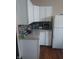 This kitchen features granite countertops, white cabinets, a tile backsplash, and stainless steel appliances at 1433 Charles St, Indianapolis, IN 46225