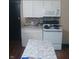 This kitchen has white cabinets, a tile backsplash, granite countertops, and stainless steel appliances at 1433 Charles St, Indianapolis, IN 46225