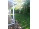 Covered porch overlooking a spacious backyard with mature trees and lush grass at 1433 Charles St, Indianapolis, IN 46225
