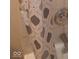 The shower has a decorative shower curtain with gray geometric shapes and a silver shower head at 1433 Charles St, Indianapolis, IN 46225