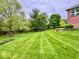 Expansive backyard with lush lawn and mature trees surrounding the property at 1544 Olive Branch Cir, Greenwood, IN 46143