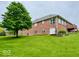 A brick home with well-kept lawns and mature trees in a spacious backyard at 1544 Olive Branch Cir, Greenwood, IN 46143