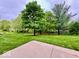 Patio with mature trees and lush green grass providing a serene outdoor space at 1544 Olive Branch Cir, Greenwood, IN 46143