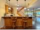 Basement bar area with a wooden countertop, stools, and bar cabinets at 1544 Olive Branch Cir, Greenwood, IN 46143