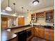 Basement bar area featuring wood cabinets, pendant lights and a countertop at 1544 Olive Branch Cir, Greenwood, IN 46143