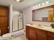 Bathroom with a vanity and a tiled shower behind a glass door at 1544 Olive Branch Cir, Greenwood, IN 46143