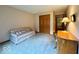 This carpeted bedroom features a couch, closet, desk, and wooden accents at 1544 Olive Branch Cir, Greenwood, IN 46143