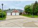 Attractive brick home features a spacious driveway and lush, green landscaping at 1544 Olive Branch Cir, Greenwood, IN 46143