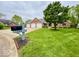 Beautifully landscaped front yard complements the brick home with a three-car garage at 1544 Olive Branch Cir, Greenwood, IN 46143