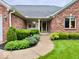 Inviting front entrance with well-maintained landscaping and a brick facade at 1544 Olive Branch Cir, Greenwood, IN 46143