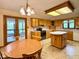Eat-in kitchen featuring wooden cabinets, a center island, and an adjacent table with backyard views at 1544 Olive Branch Cir, Greenwood, IN 46143
