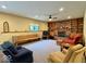 Basement living room features a brick fireplace, shelving, and neutral carpeting at 1544 Olive Branch Cir, Greenwood, IN 46143