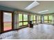 Bright sunroom featuring floor-to-ceiling windows, skylights, and a door to the backyard at 1544 Olive Branch Cir, Greenwood, IN 46143