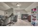 Finished attic space with neutral carpet, bright lighting, functional desk space and shelving for storage at 1617 E Kelly St, Indianapolis, IN 46203