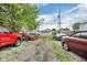 Wide backyard and driveway with multiple parked cars and glimpses of neighboring homes in the area at 1617 E Kelly St, Indianapolis, IN 46203