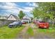 View of the backyard and driveway, complete with multiple vehicles and a glimpse of the property's exterior at 1617 E Kelly St, Indianapolis, IN 46203
