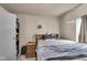Simple bedroom features carpeted floors, a bed, dresser, and natural light from window at 1617 E Kelly St, Indianapolis, IN 46203