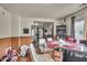 Bright dining area with a glass table, seating for six, paneled walls, and hardwood floors at 1617 E Kelly St, Indianapolis, IN 46203