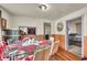 Dining area with a glass table set for four, wood floors, and paneled walls at 1617 E Kelly St, Indianapolis, IN 46203