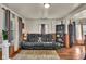 Inviting living room featuring hardwood floors, large sofa, bookshelves, and ample natural light at 1617 E Kelly St, Indianapolis, IN 46203