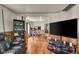 Cozy living space with hardwood floors open to dining area and equipped with a big tv at 1617 E Kelly St, Indianapolis, IN 46203