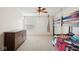 Shared bedroom with a bunk bed, dresser, ceiling fan, and window offering comfortable living space at 16264 Red Clover Ln, Noblesville, IN 46062
