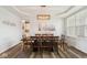 Elegant dining room featuring a large wooden table, chandelier, and wood floors at 16264 Red Clover Ln, Noblesville, IN 46062